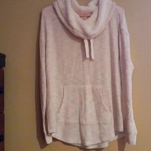 A tan funnel neck blouse